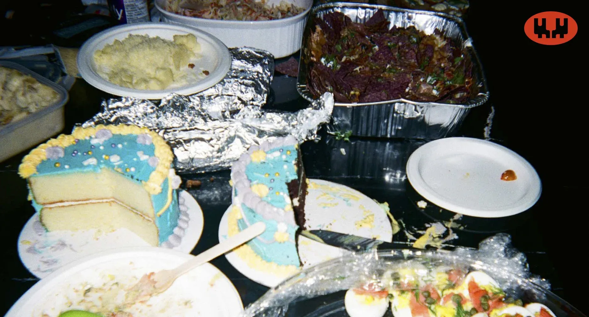 Final shot of Fond dinner party, picture is a table with half eaten cake and other dishes